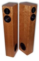 Pair of HT3 tower speakers in cherry veneer, front and side view with the side-firing woofer