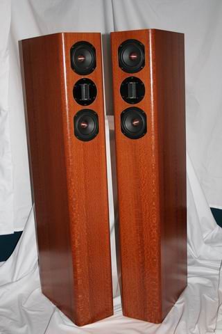 Pair of HT8 tower speakers in wood veneer: a ribbon tweeter between two midrange drivers on the front, the side-firing woofers lower down